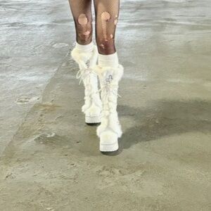 custom white fur boots with cross detailing